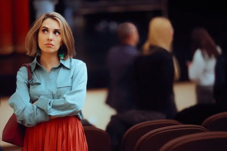 A woman standing alone at a conference