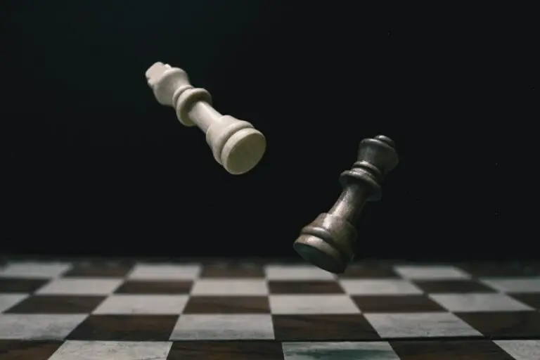 White pawn on a black and white chessboard symbolising leadership intervention, strategic thinking, and managing workplace pressure.
